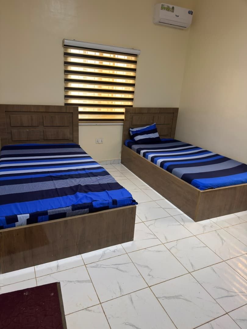Two-bed room with air conditioning and window blinds